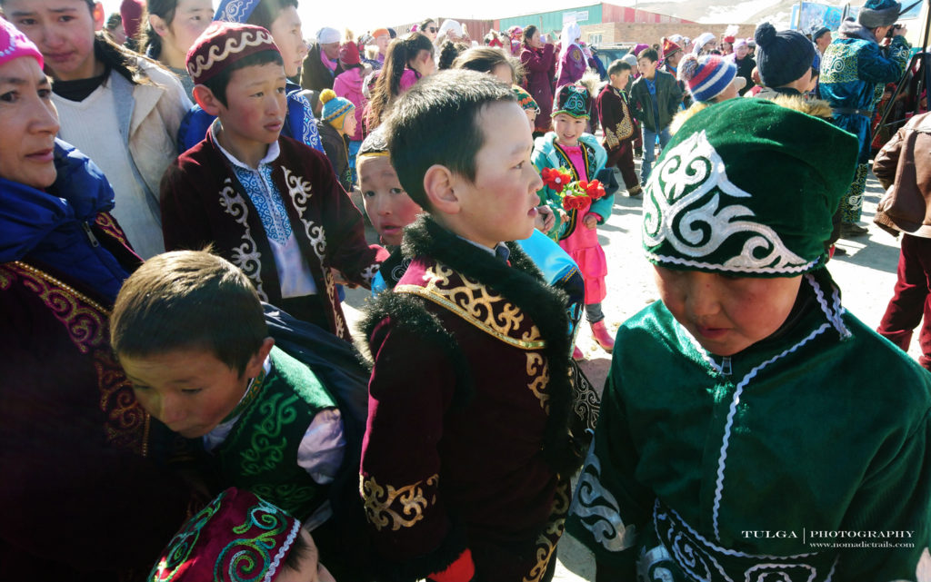 Kids in traditional clothes at Golden Eagle festival site