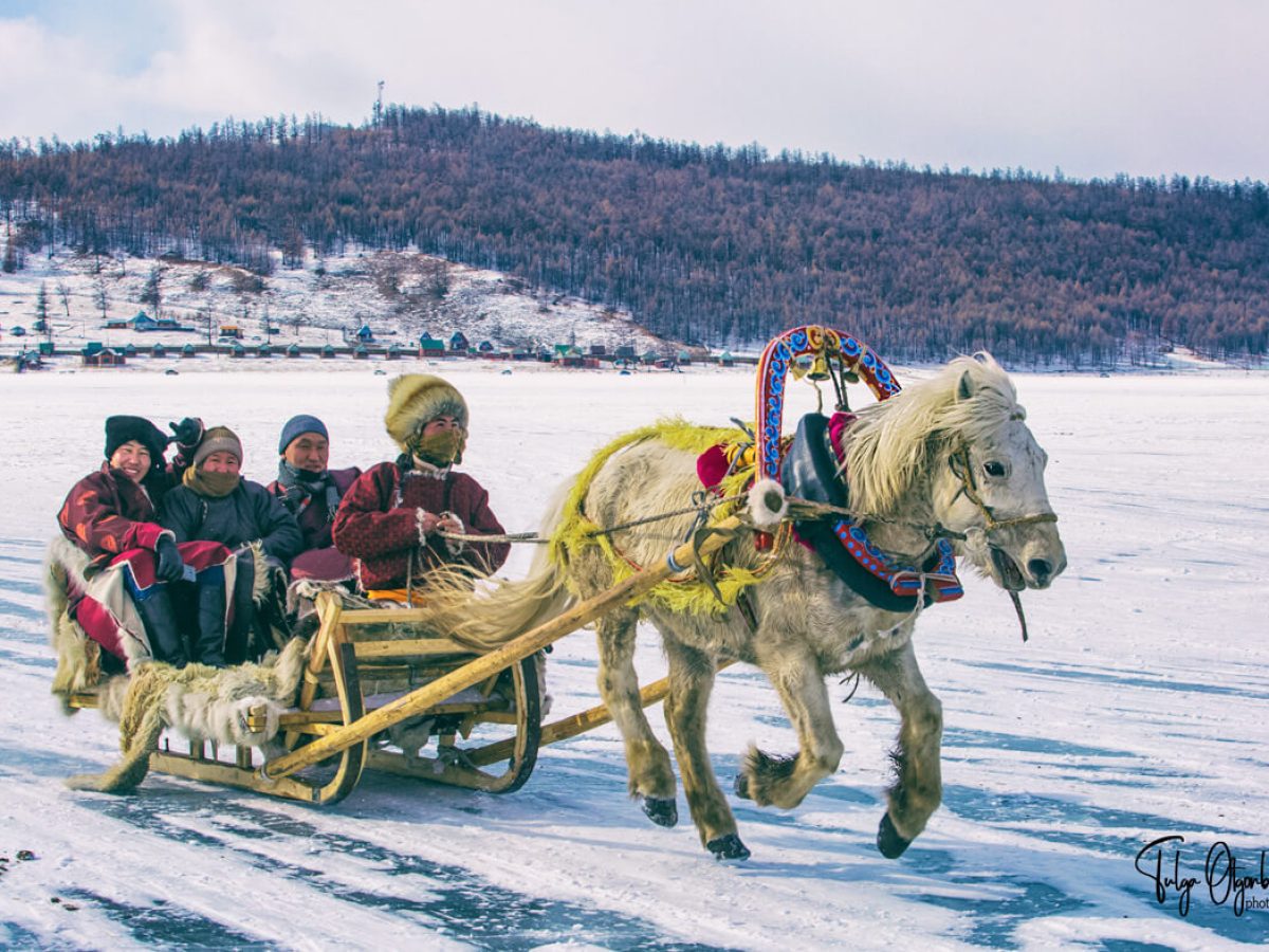 Horse sled ride across frozen Khuvsgul lake Mongolia