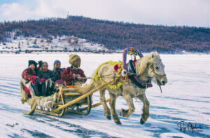 Horse sled ride across frozen Khuvsgul lake Mongolia