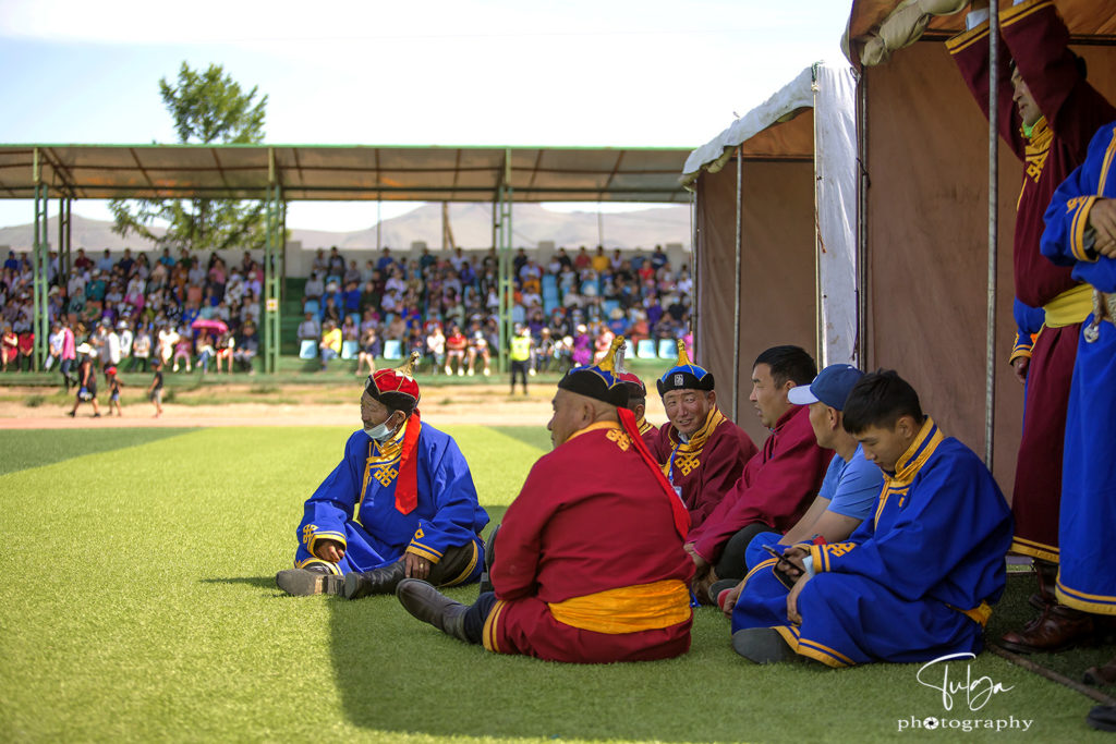 Men at naadam in deel - traditional mongolian garment