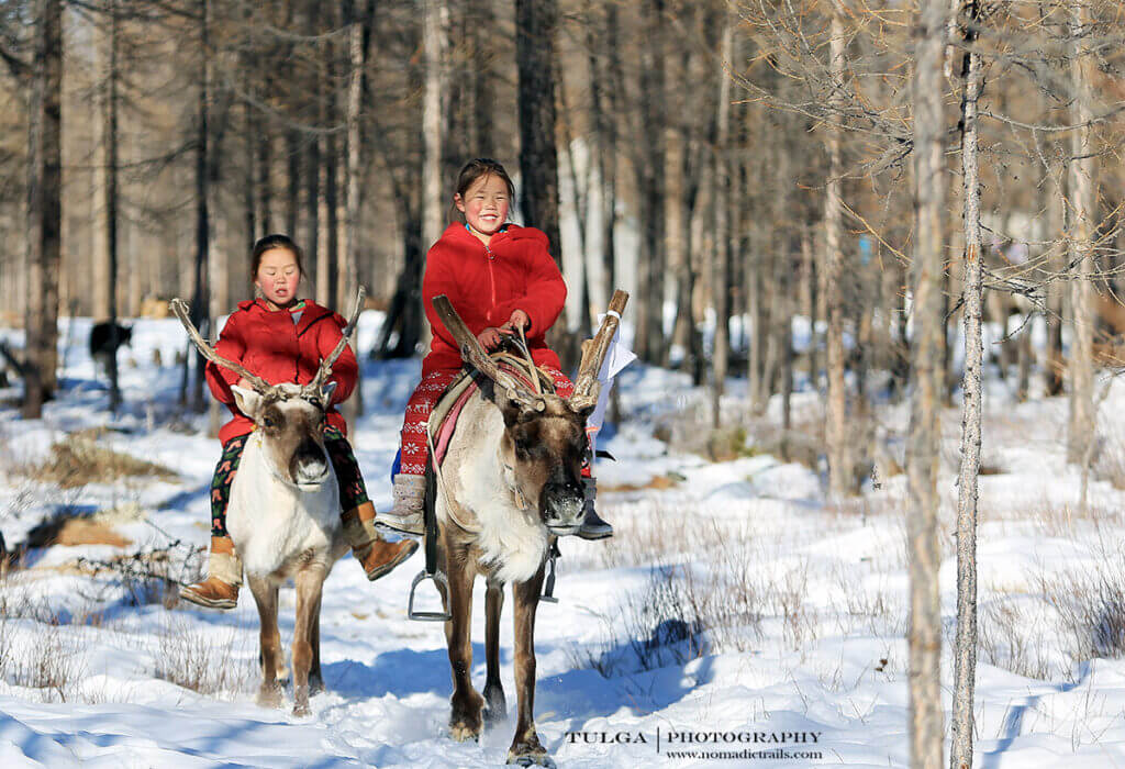 Reindeer herder kids just go out and ride their reindeer almost every day